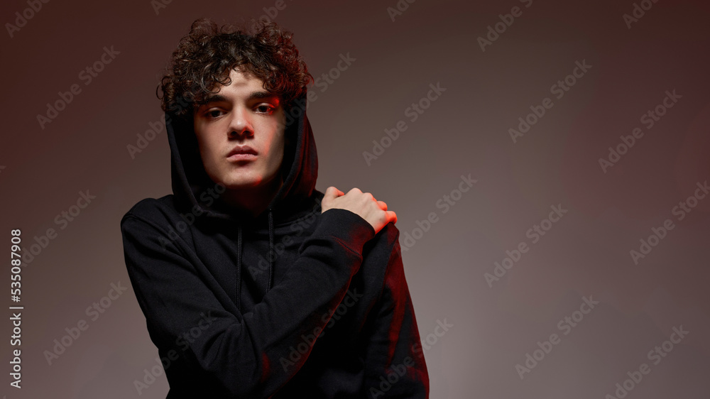 Curly caucasian teenage boy looking at camera Curly caucasian teenage boy looking at camera