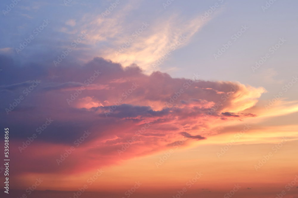 Big clouds in the red sunset sky. Evening sky in bright sunlight