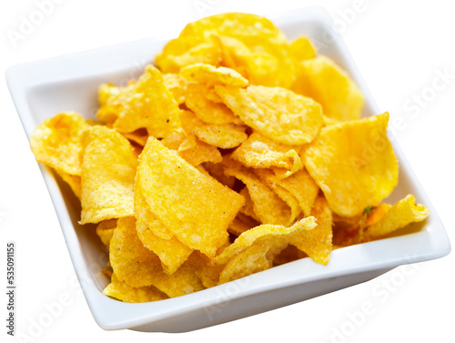 Close-Up Of tasty potato chips or crisps in white square ceramic plate. Isolated over white background