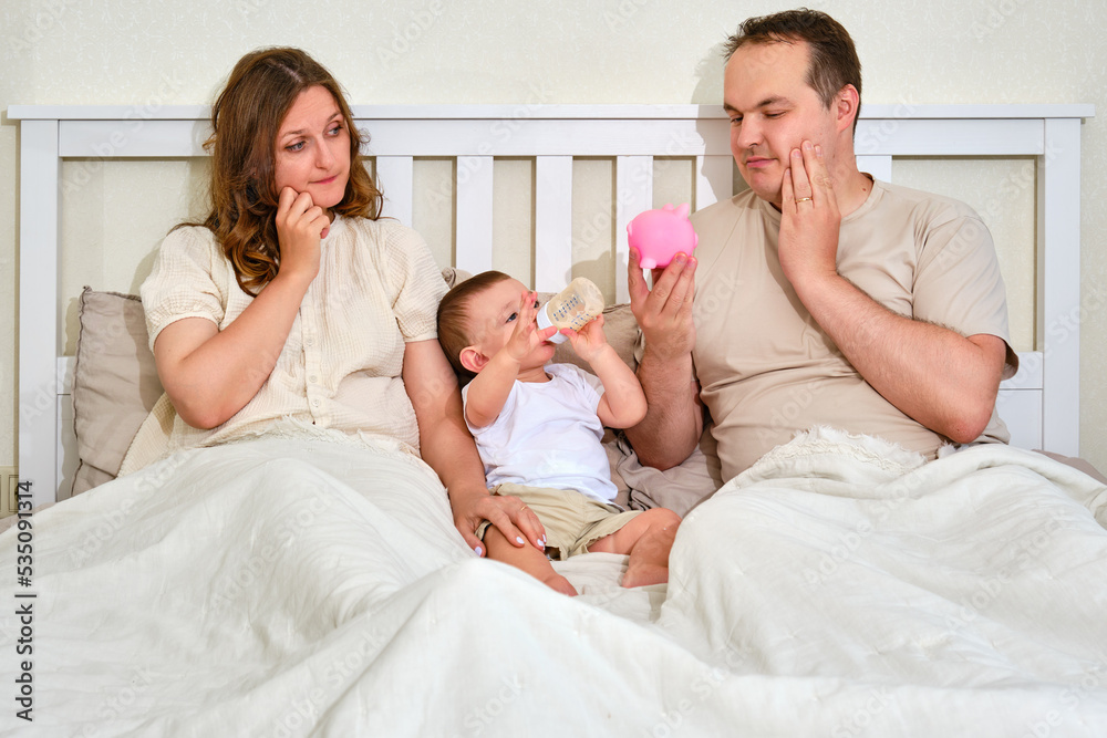 Doubt mother, fatherb and baby boy with money for upbringing, financial problems of parents with infant child. Man and woman consider family budget with toddler baby in bedroom