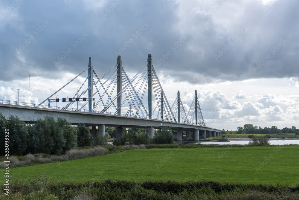 The Tacitus bridge (Tacitusbrug) over the river Waal between the villages Ewijk and Herveld, the Netherlands The Tacitus bridge (Tacitusbrug) over the river Waal between the villages Ewijk and Herveld, the Netherlands