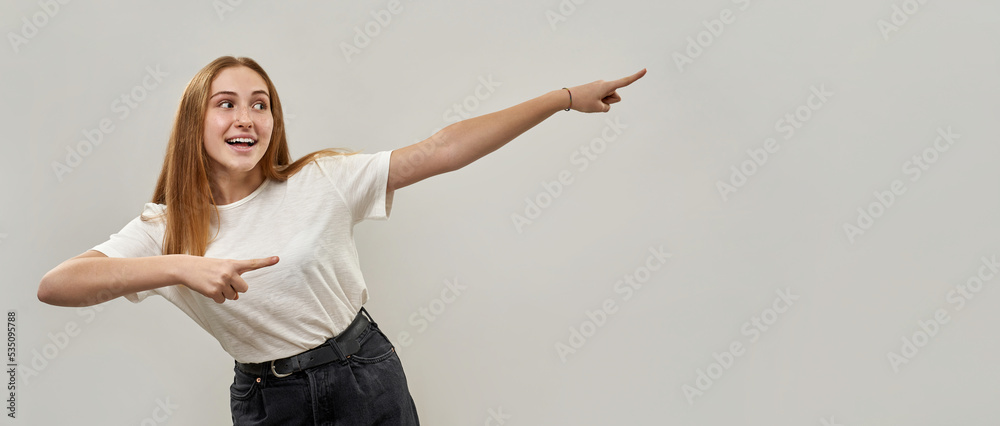 Caucasian girl point with fingers and look away Caucasian girl point with fingers and look away