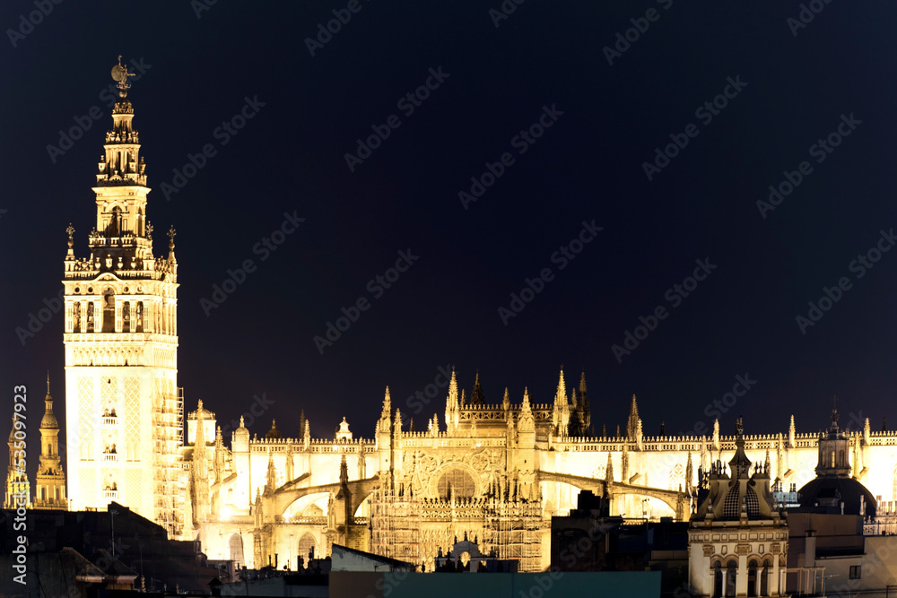 Obraz premium La Giralda the most famous tower with the Cathedral in Seville Andalusia Spain Europe at night