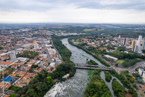 Aerial photography of the city of Piracicaba. Rua do Porto, recreation parks, cars, lots of vegetation and the Piracicaba river crossing the city. photo