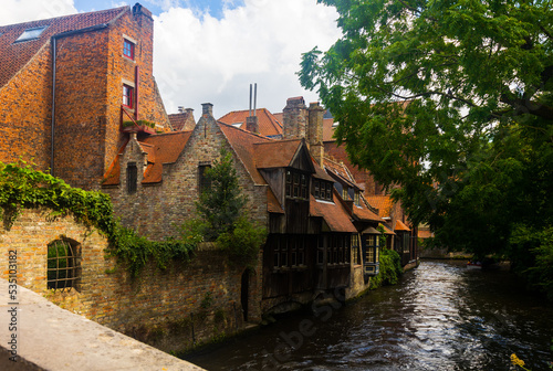 Summer landscape with a view of houses and canals in the city of Brugge, the capital of West Flanders, Belgium