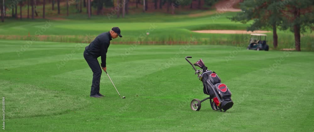 MED Caucasian man playing golf, striking a ball during the course. Super slow motion shot MED Caucasian man playing golf, striking a ball during the course. Super slow motion shot