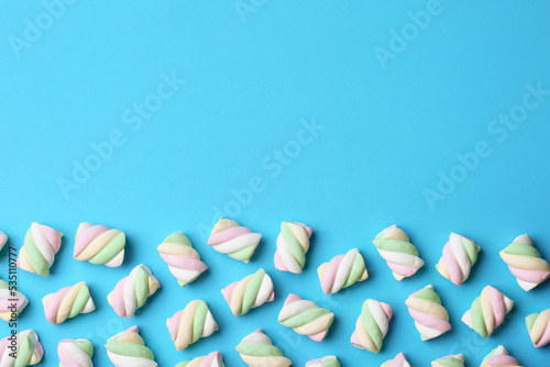 Photos Delicious colorful marshmallows on light blue background, flat lay