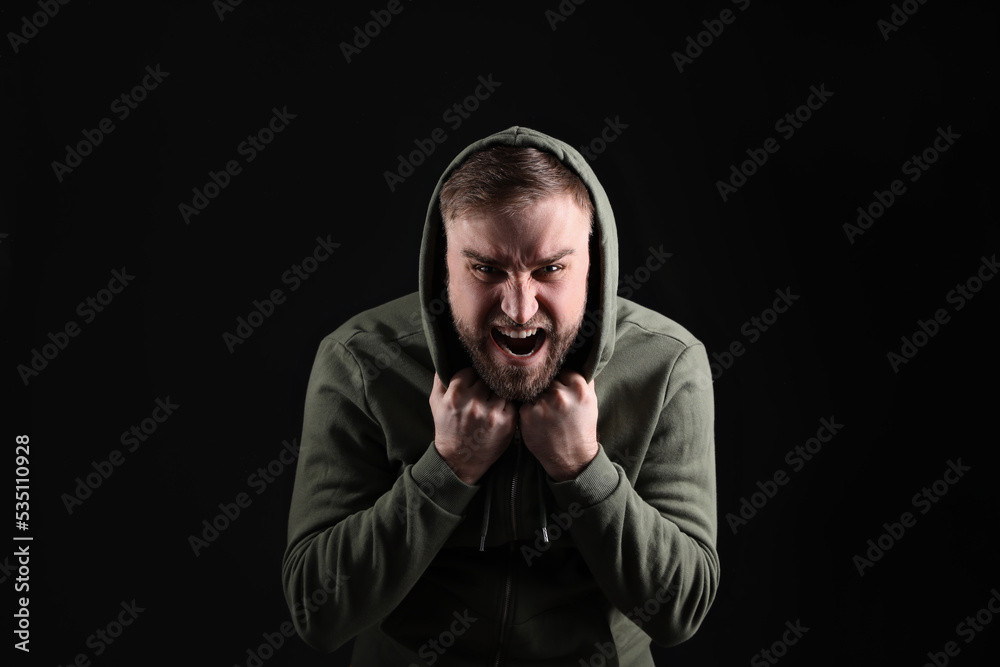 Portrait of emotional young man on black background. Personality concept