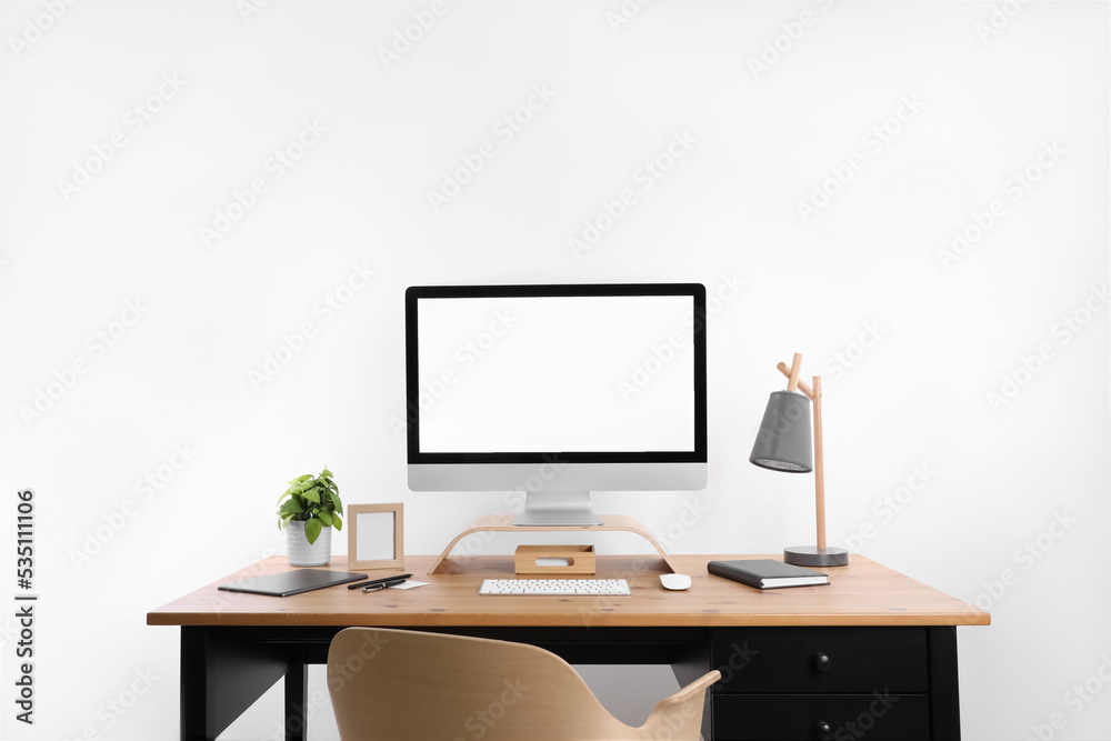 Modern computer with blank screen on desk, space for design. Comfortable workplace Modern computer with blank screen on desk, space for design. Comfortable workplace