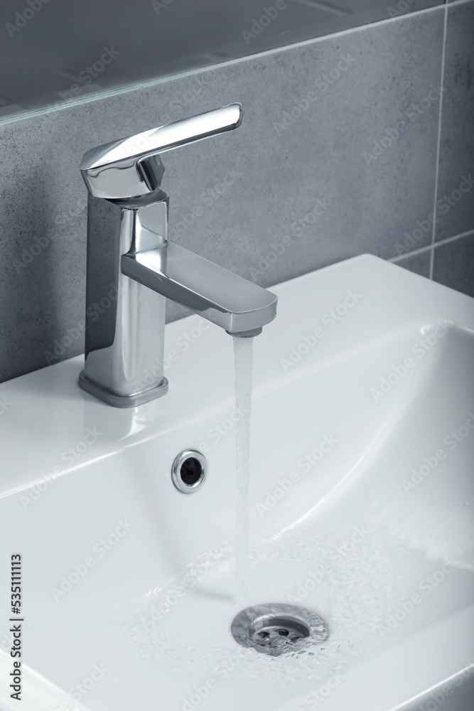 Stream of water flowing from tap in bathroom Stream of water flowing from tap in bathroom