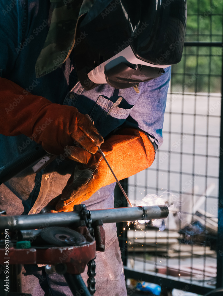 Iron soldering, Man working on iron soldering, welding sparks