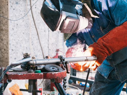 Iron soldering, Man working on iron soldering, welding sparks