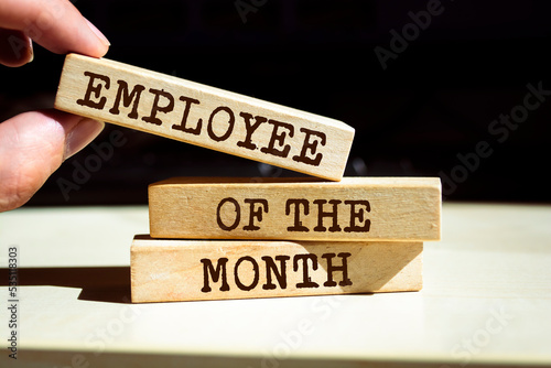 Wooden blocks with words 'Employee of the Month'.