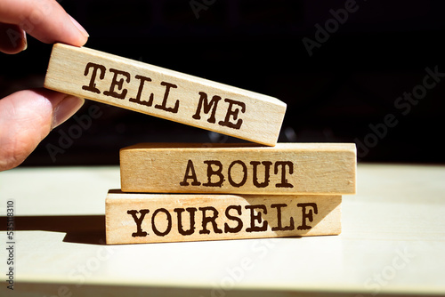 Wooden blocks with words 'Tell Me About Yourself'.