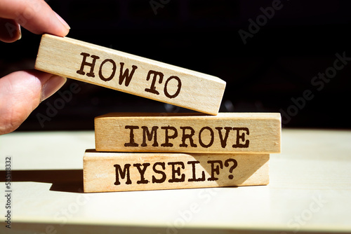 Wooden blocks with words 'How To Improve Myself?'.