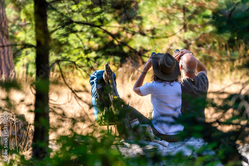 Bird watchers during fall colors in Oregon forest