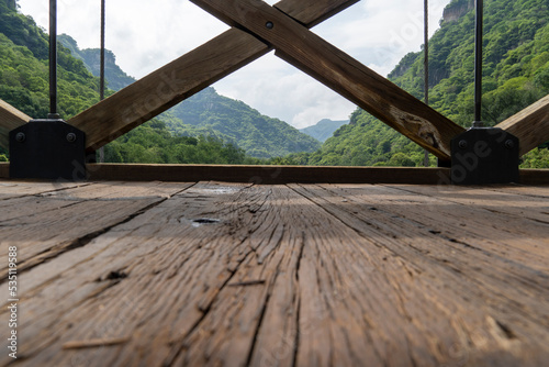 barranca huentitan, guadalajara, old wooden floor, wooden beams and crossbeams, mountains and tensioned cables, vegetation in the background