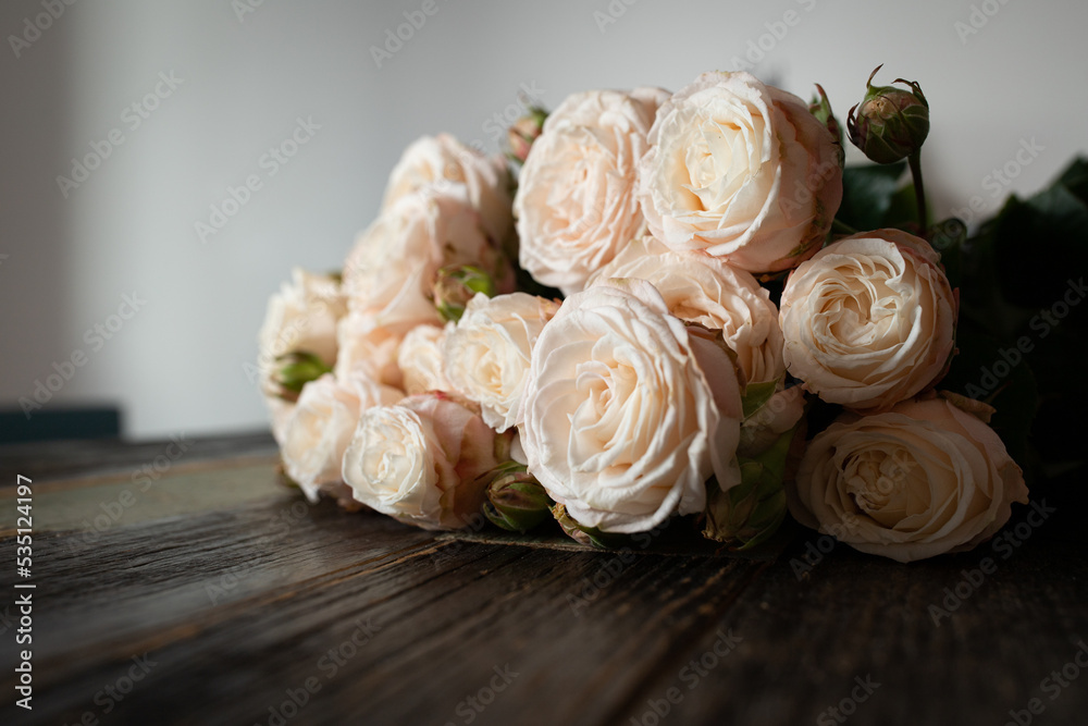 Bouquet of pink roses on a wooden background. The concept of delivering flowers, gifts and congratulations. Front view.