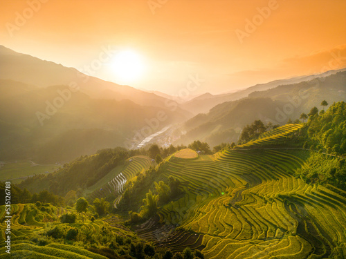 Aerial view of golden rice terraces at Mu cang chai town near Sapa city, north of Vietnam. Beautiful terraced rice field in harvest season in Yen Bai, Vietnam © CravenA
