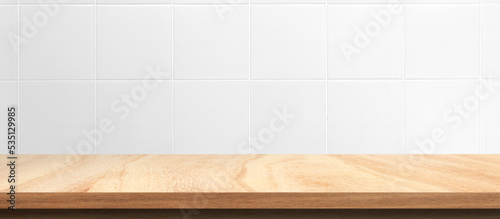 Empty wooden table on square ceramic tile wall for mockup product display.. © chathuporn