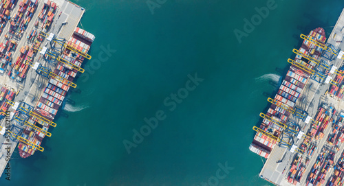 Aerial top view of Container ship loading and unloading, Cargo container in deep seaport for the international order. Transportation and travel concept.