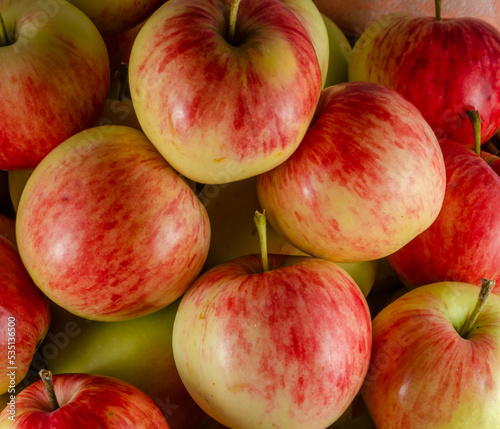 Ripe red and yellow apples in large quantities.