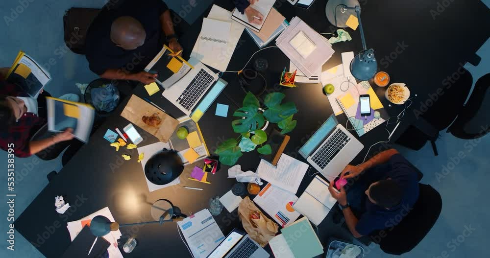 Teamwork, meeting and collaboration with a team being busy in an office and working with paperwork around a table. Training, workshop and development with a group of business people at work together