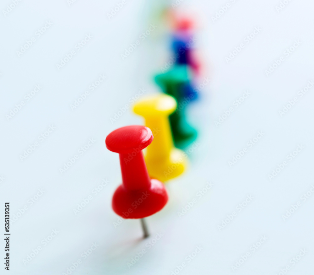 Push pins in a row isolated on white Push pins in a row isolated on white