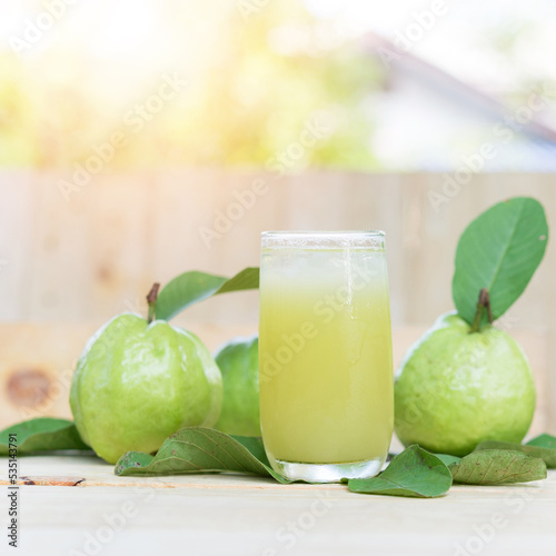 Guava juice, Guava water with Guava fruit, high Vitamin C, green drink, on wood background