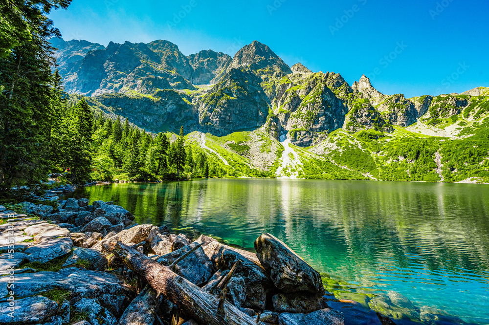 Tatra National Park in Poland. Famous mountains lake Morskie oko or sea eye lake In High Tatras. Five lakes valley - obrazy, fototapety, plakaty 