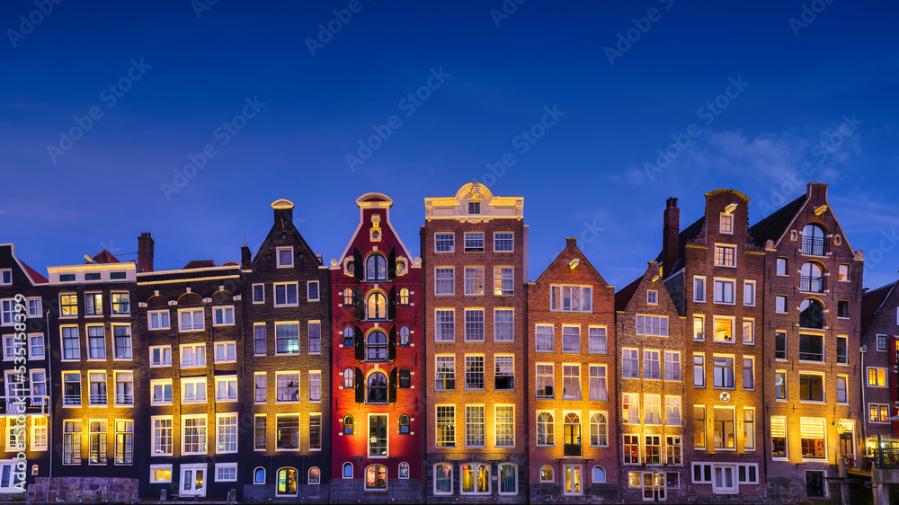 Amsterdam, Netherlands. View of houses during sunset. The famous Dutch canals. A cityscape in the evening. Travel photography.