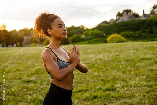 Young black woman meditating during yoga practice