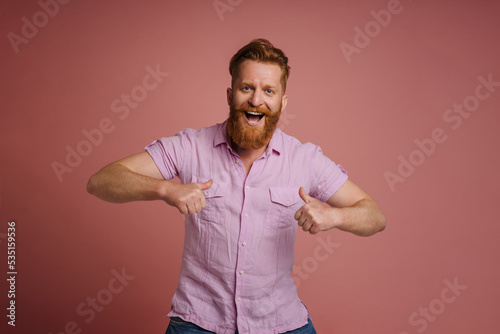 Ginger white man with beard screaming and pointing fingers at himself