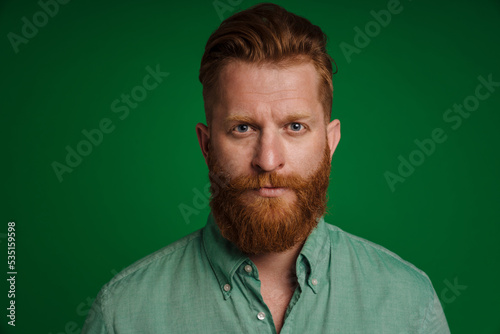 Ginger white man with beard posing and looking at camera