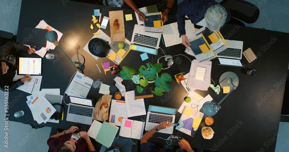 Top view, portfolio and digital marketing project meeting with manager giving out business documents to workers. Team of creative employees planning an seo strategy, branding and logo advertising