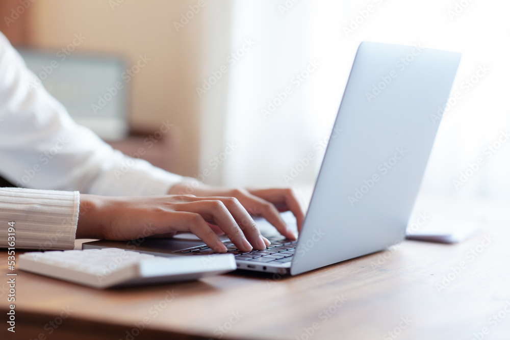 business woman drinking coffee and working on wooden table at home Using a laptop and computer to assess and analyze the economy to invest successfully in his own business, business ideas. business woman drinking coffee and working on wooden table at home Using a laptop and computer to assess and analyze the economy to invest successfully in his own business, business ideas.
