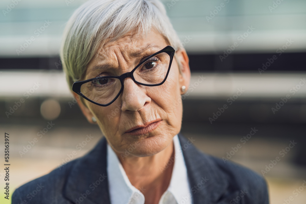 Close up portrait of senior businesswoman who is sad and worried. Close up portrait of senior businesswoman who is sad and worried.