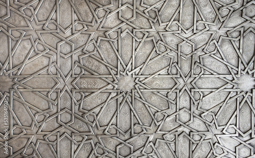 Detail of metal door with traditional islamic ornament. Copper shutter with antique and national moroccan floral pattern