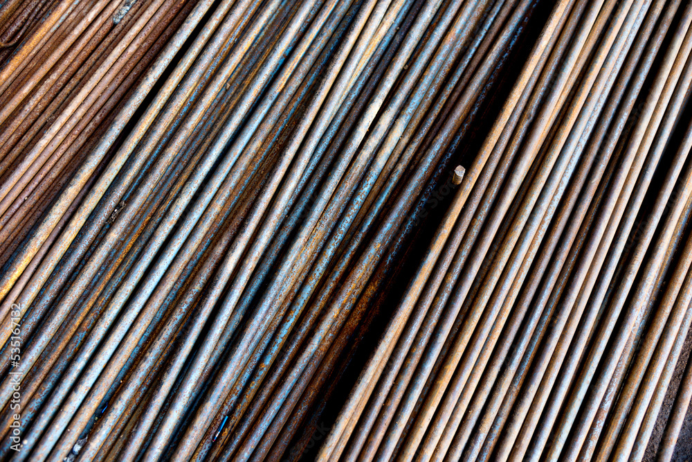 Obraz premium Round steel bars on pile in the warehouse