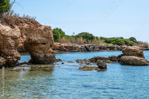 Beautiful beach with crystal clear water and a natural rock arch in Sicily in Syracuse