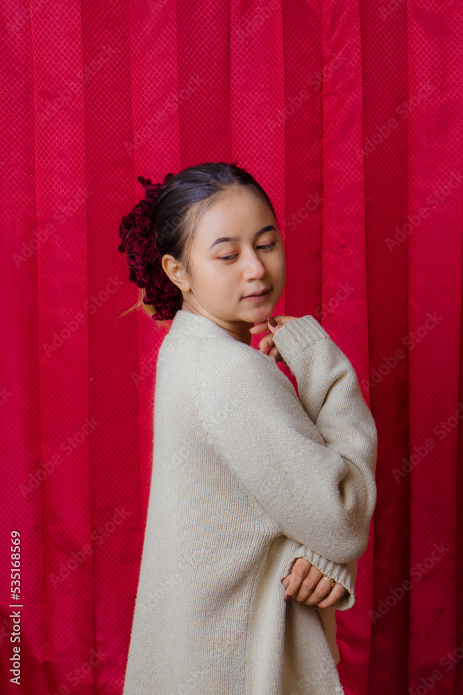 Portrait of cheerful beautiful Asian Woman in casual shirt. Beautiful asian female model posing in studio on red background. Portrait of cheerful beautiful Asian Woman in casual shirt. Beautiful asian female model posing in studio on red background.
