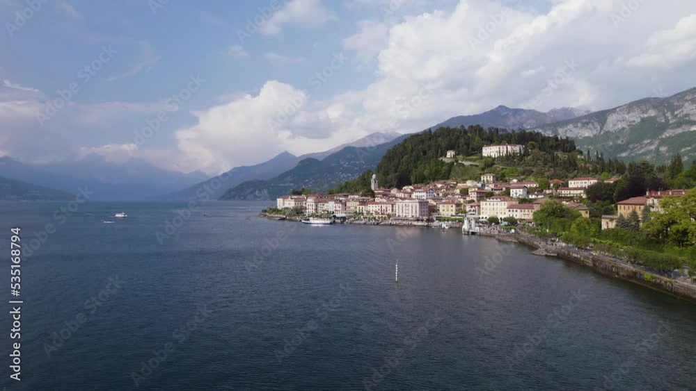 Boats Sailing On Lake Como In Bellagio, Italy With View Of Prestigious Waterfront Hotels At Daytime. wide aerial Boats Sailing On Lake Como In Bellagio, Italy With View Of Prestigious Waterfront Hotels At Daytime. wide aerial