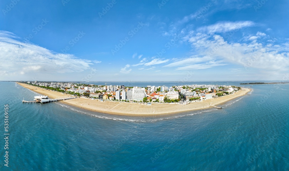 Lignano Sabbiadoro panoramica aerea della spiaggia sul mare  con cielo blu