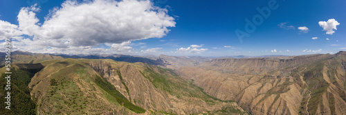 An ancient abandoned city is the village of Gamsutl on top of a mountain in Dagestan. A popular attraction. View from above from the drone. Vertical panorama. Tourist destination in Russia.