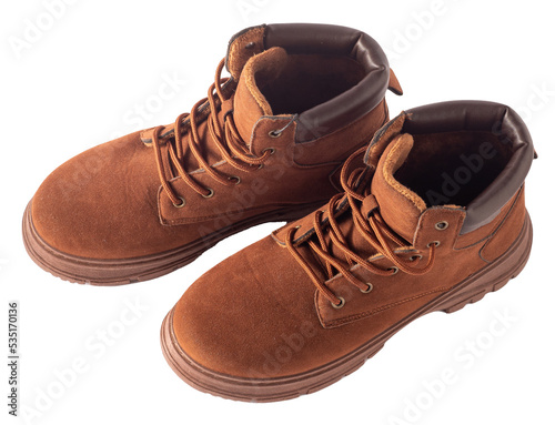 Brown suede boots isolated on white background. Shoes for autumn and winter unisex casual. A pair of boots with laces and tractor soles.