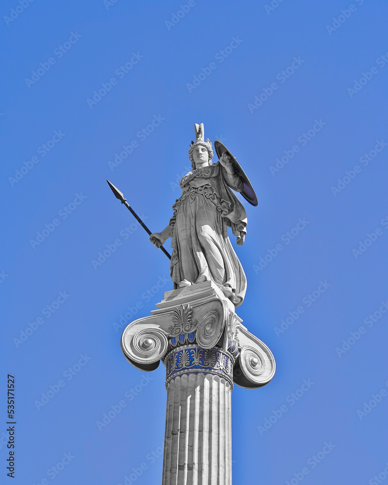 Athena statue, the ancient Greek goddess of wisdom and science, on a Corinthian style column with blue sky background. Athens, Greece. Filtered image. Athena statue, the ancient Greek goddess of wisdom and science, on a Corinthian style column with blue sky background. Athens, Greece. Filtered image.
