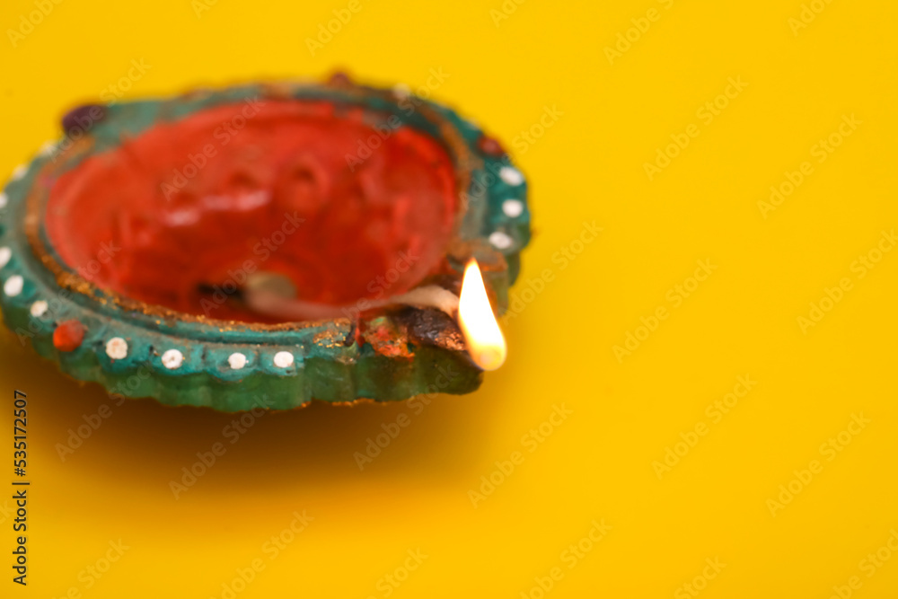 Concept of indian festival diwali. Traditional oil lamps on yellow background. Concept of indian festival diwali. Traditional oil lamps on yellow background.