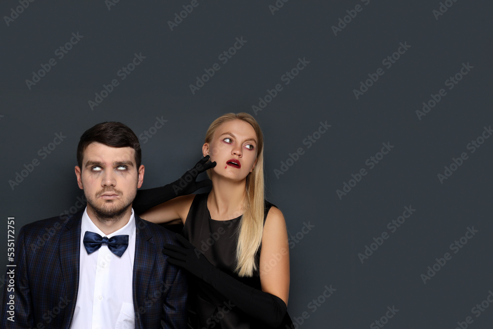Concept of Halloween, young man and woman on dark background Concept of Halloween, young man and woman on dark background