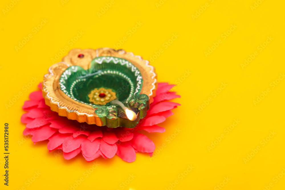 Concept of indian festival diwali. Traditional oil lamps on yellow background. Concept of indian festival diwali. Traditional oil lamps on yellow background.