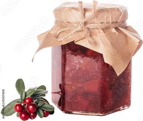 Jar of homemade lingonberry and pear jam with craft paper on lid next to fresh lingonberries isolated on white background. Autumn homemade preparations, stock of food for winter